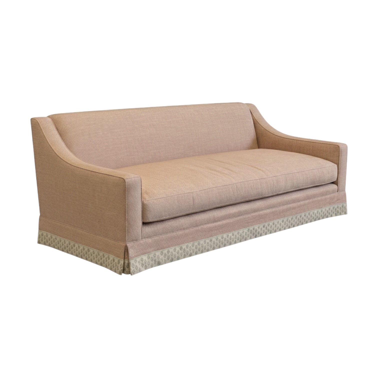 The Grant Sofa by Bunny Williams features a light brown skirt, curved arms, a single seat cushion, and a patterned skirt along the bottom edge, displayed against a white background.