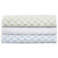 Three folded quilts from the Layla Bedding Collection by John Robshaw are stacked neatly, each crafted from soft cotton voile and adorned with an embroidered geometric flower pattern in green, white, and blue on a crisp white background. Inspired by the artistry of Mughal gardens, these luxurious bedding layers create a visually striking display.
