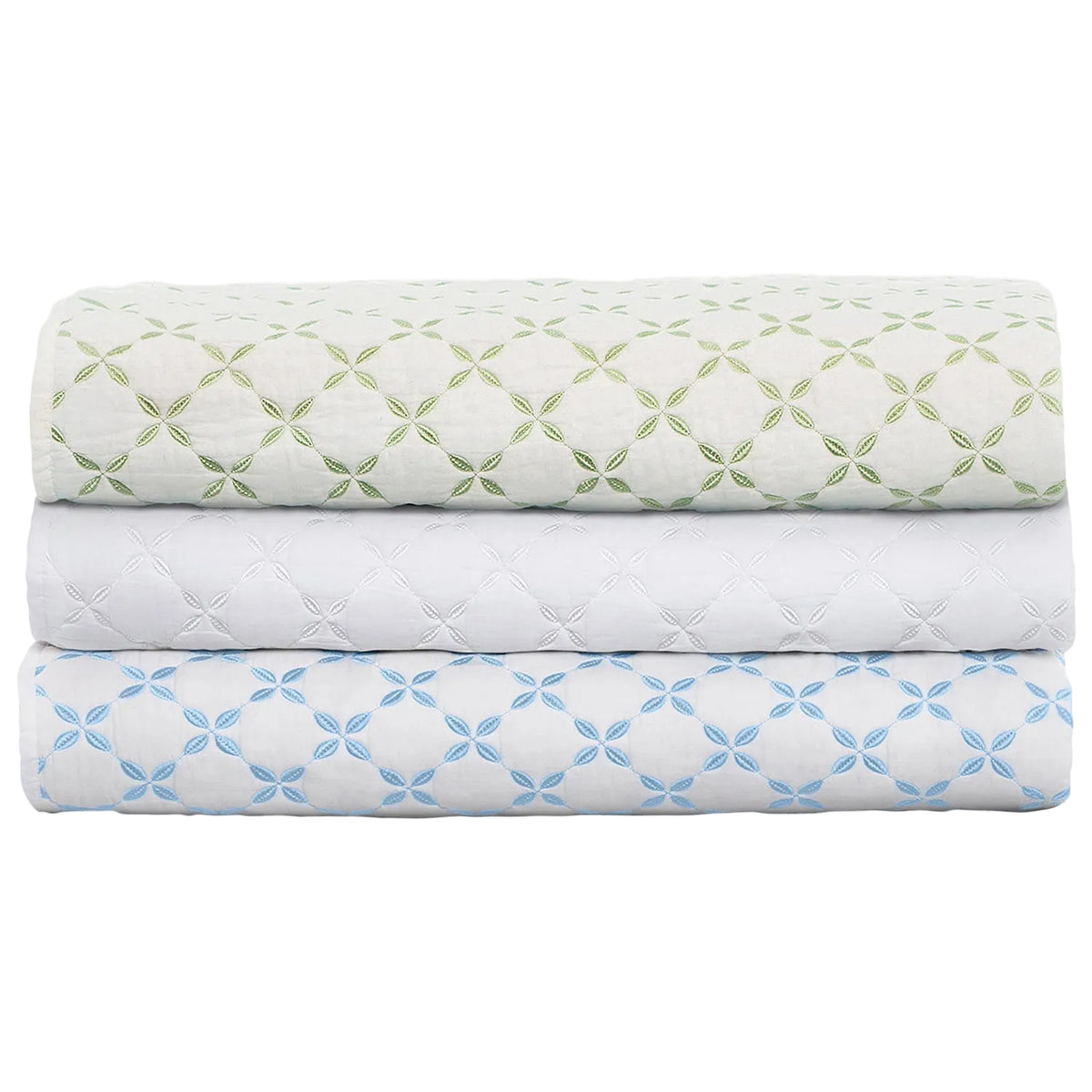 Three folded quilts from the Layla Bedding Collection by John Robshaw are stacked neatly, each crafted from soft cotton voile and adorned with an embroidered geometric flower pattern in green, white, and blue on a crisp white background. Inspired by the artistry of Mughal gardens, these luxurious bedding layers create a visually striking display.