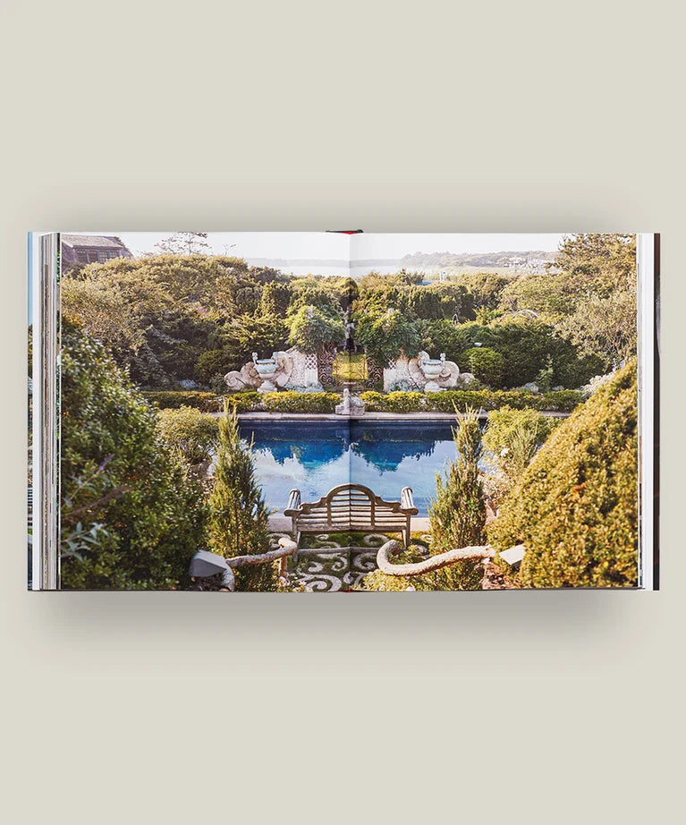 Open book displaying a garden with a central pool, surrounded by lush greenery, manicured hedges, and decorative statues in the background—an inviting scene echoing the refined elegance of country estates and exquisitely depicted in monographs like *Pietro Cicognani: Architecture and Design* by Common Ground.