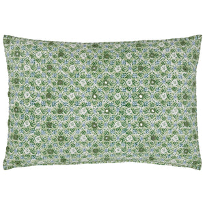 The Ankur Kidney Pillow by John Robshaw is a rectangular pillow adorned with green and white hand-printed florals, medallions, and small smiling face motifs repeated across its surface.