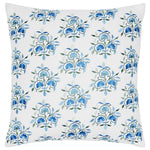 The Ankur Azure Pillow by John Robshaw features a square shape with a white background and a repeating pattern of blue and green embroidered flowers, crafted from soft cotton linen. It includes a hidden zipper closure for easy care and a seamless look.