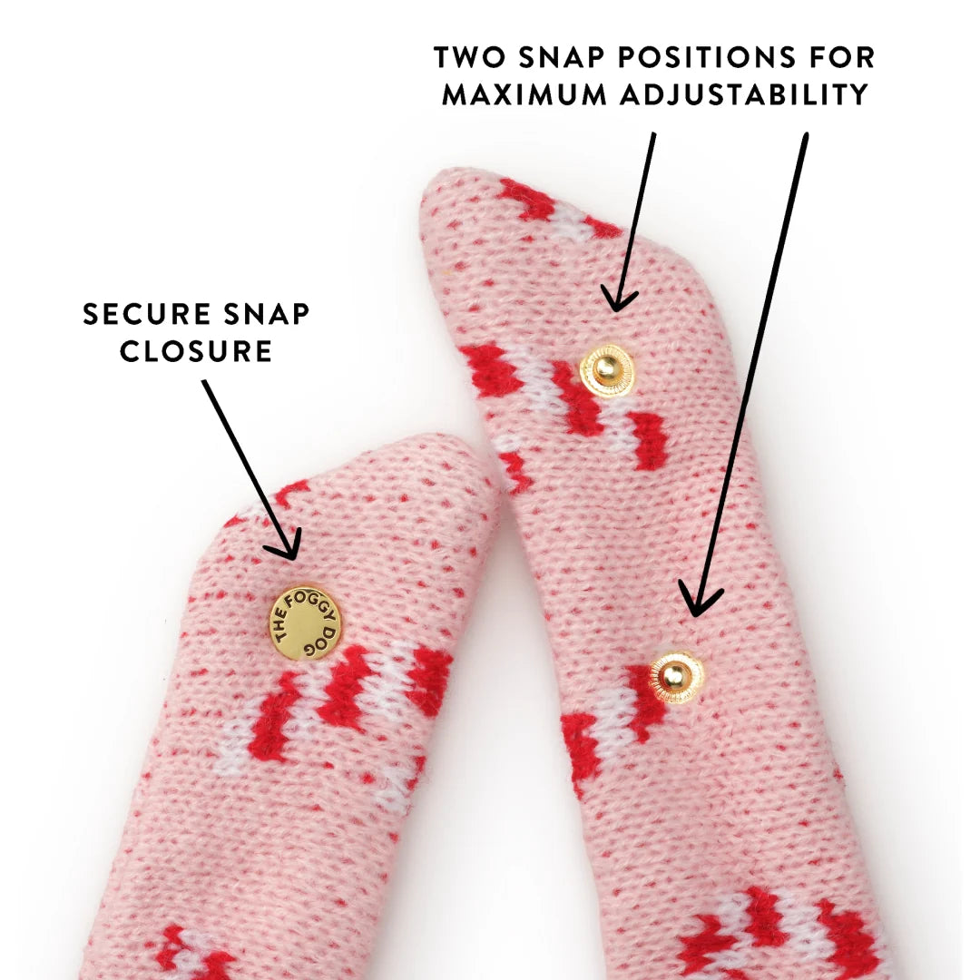 Pink Candy Canes Knit Dog Bandana in pink with gold snap closures and text pointing to the fasteners to indicate a secure fit and adjustable sizing.