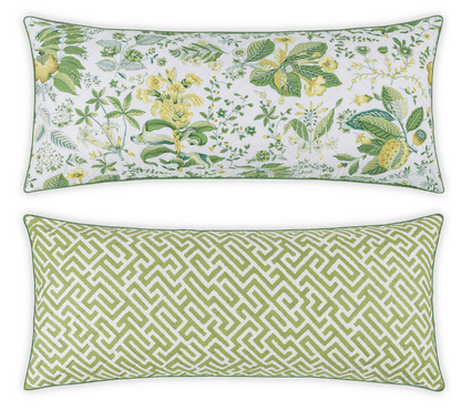 The Matouk Reversible Lumbar Pillow Collection includes two rectangular pillows: one with a green and yellow floral print, the other with a green geometric pattern on white—perfect for customizable home decor.