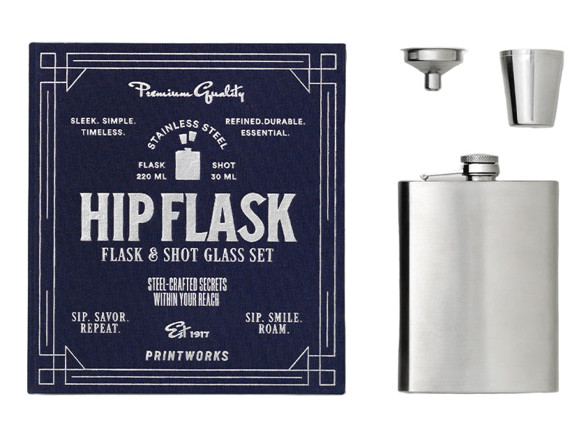 The Essentials Hip Flask by PrintWorks includes a stainless steel flask, metal shot glass, and funnel, presented with navy packaging. A sleek gift set for any occasion.