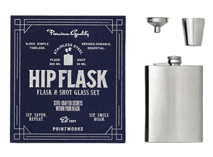 The Essentials Hip Flask by PrintWorks includes a stainless steel flask, metal shot glass, and funnel, presented with navy packaging. A sleek gift set for any occasion.