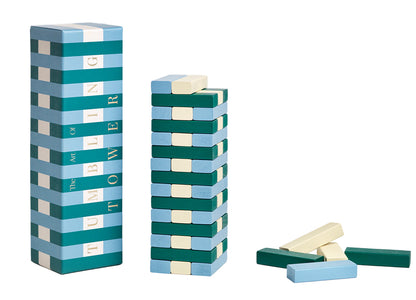 The PrintWorks Tumbling Tower is a solid wood game set featuring blue, green, and cream rectangular blocks, shown with its box and loose pieces on a white background—perfect for your next game night.