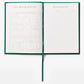 The PrintWorks Book Club Reading Journal displays “My Bookshelf” with book illustrations and a “Book Wishlist,” ideal for tracking your reading progress, listing wish-list titles, authors, purchase dates, and adding brief book reviews.