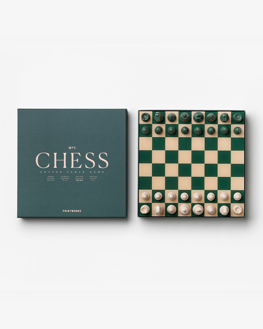 The PrintWorks Chess Collection features modern green and cream pieces on a matching board, ideal for coffee table games, and comes in a box labeled "CHESS.