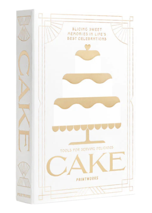 A white and gold box from PrintWorks featuring a three-tiered cake illustration and "The Essentials Cake Tools"—perfect as a Cake Kit or stylish kitchen decor.