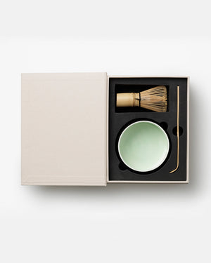 Discover The Essentials Matcha Tools x Cafe Kitsuné by PrintWorks: a boxed set with bamboo whisk, light green ceramic bowl, and metal scoop—all nestled in foam. Ideal for Café Kitsuné fans and matcha lovers alike.