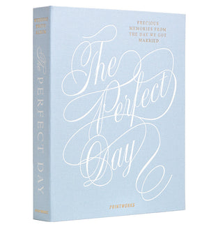 PrintWorks’ “The Perfect Day Wedding Photo Album” features a light blue cloth cover with white script and gold text: “Precious memories from the day we got married.”.