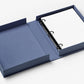 The PrintWorks Blue Picture Perfect Photo Album lies open, displaying a ring-bound stack of high-quality photo paper on the right and an empty compartment on the left.