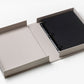 An open beige box displays the PrintWorks "You Are The Sunshine Of My Life" Photo Album—a black three-ring binder with blank black pages—perfect for adding a sophisticated touch to your home decor, set on a white surface.