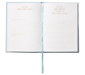 The Perfect Day Wedding Planner by PrintWorks features "Our Priorities" and "Our Shared Top 3 Priorities" sections with lined spaces for planning your dream wedding, plus a light blue ribbon bookmark.