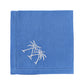 The Pink House Mustique Dinner Napkin Set features square blue linen napkins with white embroidered twin palm trees in one corner—an ideal addition to any luxury table linens collection.