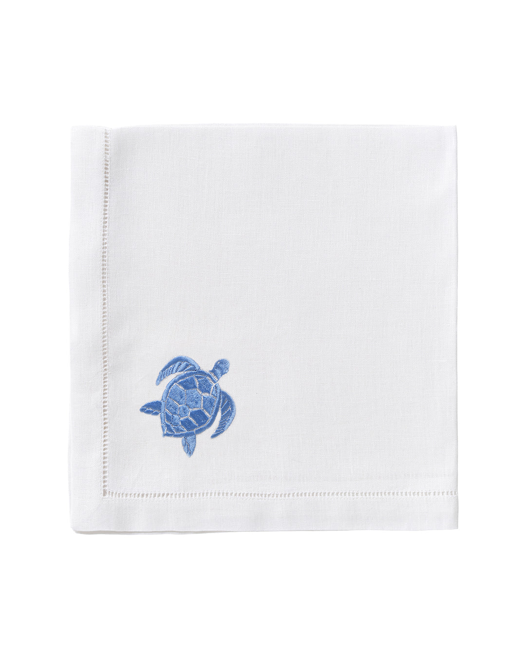 The Pink House Mustique Dinner Napkin Set features white linen napkins with a small blue embroidered sea turtle in one corner, perfect for adding charm to your luxury table linens collection.