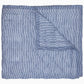 The Nandi Bedding Collection by John Robshaw is displayed partially folded back, highlighting its blue and white pinstriped design on both sides and showcasing the artisanal detail of hand-quilted craftsmanship.