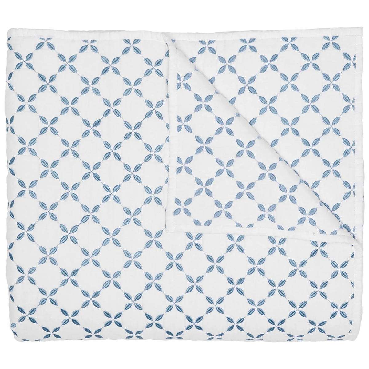 Introducing the Layla Bedding Collection by John Robshaw: a folded white quilt adorned with a repeating pattern of blue interlocking circles and four-petal flower motifs, inspired by the timeless elegance of Mughal gardens. Crafted from soft cotton voile, it’s the perfect bedding layer for year-round comfort.