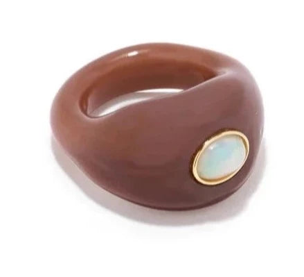 Chestnut-colored domed glass ring set with turquoise cabochon