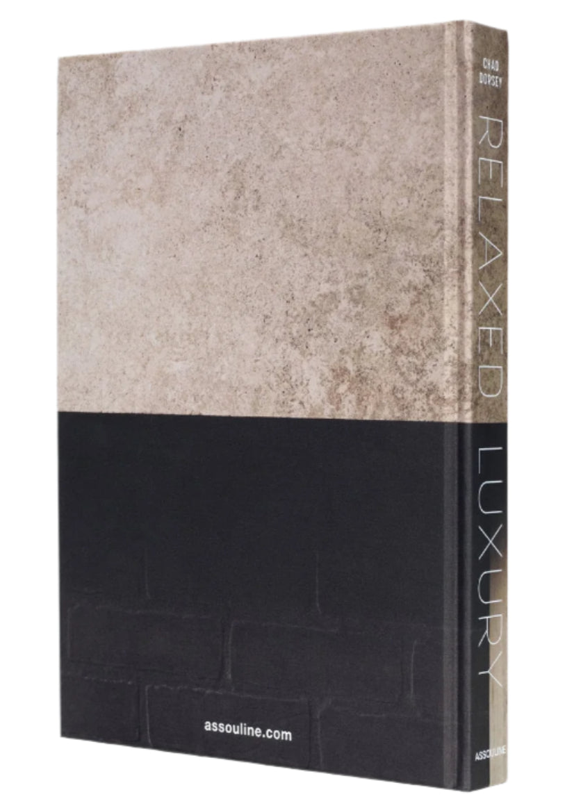 Relaxed Luxury" by Assouline is a hardcover interior design book with a textured beige and black cover, featuring the publisher’s website assouline.com at the bottom.