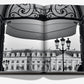 Open book displaying a black-and-white photo of the Ritz Paris, seen through ornate gates at Place Vendôme, with elegant street lamps in the foreground. The book titled "Eternally Ritz" by Assouline captures this iconic scene.