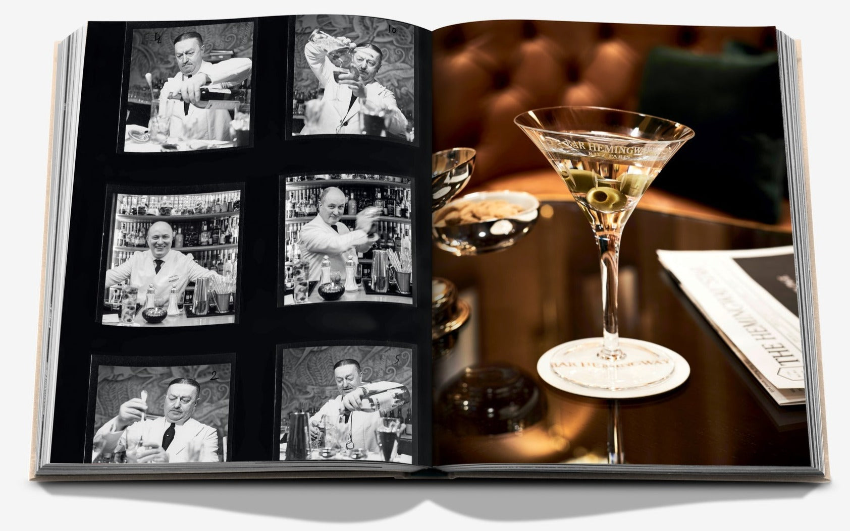 Open book showing black-and-white photos on the left of a bartender making cocktails and a color image on the right of a martini glass with olives, evoking the elegance of Place Vendôme, resting on a table alongside reading materials, featuring "Eternally Ritz" by Assouline.