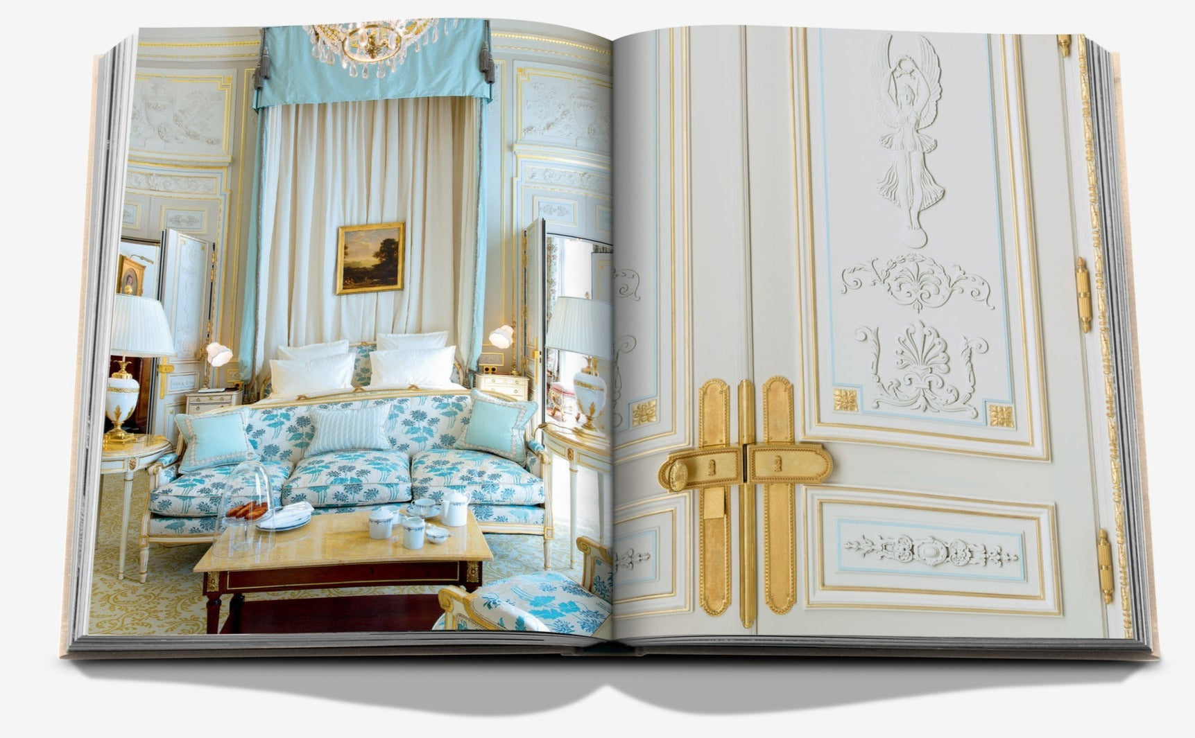 An open book displaying a lavishly decorated room with ornate furniture, a bed, and elegant white and gold detailing on the walls evokes the opulence of a luxury hotel. The right page shows a close-up of a richly adorned door reminiscent of the grandeur found at Ritz Paris. This is "Eternally Ritz" by Assouline.