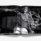 Open book featuring a dynamic double exposure black-and-white photo of tennis legend Roger Federer in action with his racket, creating an extraordinary visual biography. (Product Name: Federer, Brand Name: Assouline)