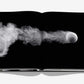 The book "Federer" by Assouline is a visual biography that includes a striking black-and-white image of a tennis ball in motion, enveloped by a cloud of dust or smoke against a dark backdrop, paying homage to tennis legend Roger Federer.