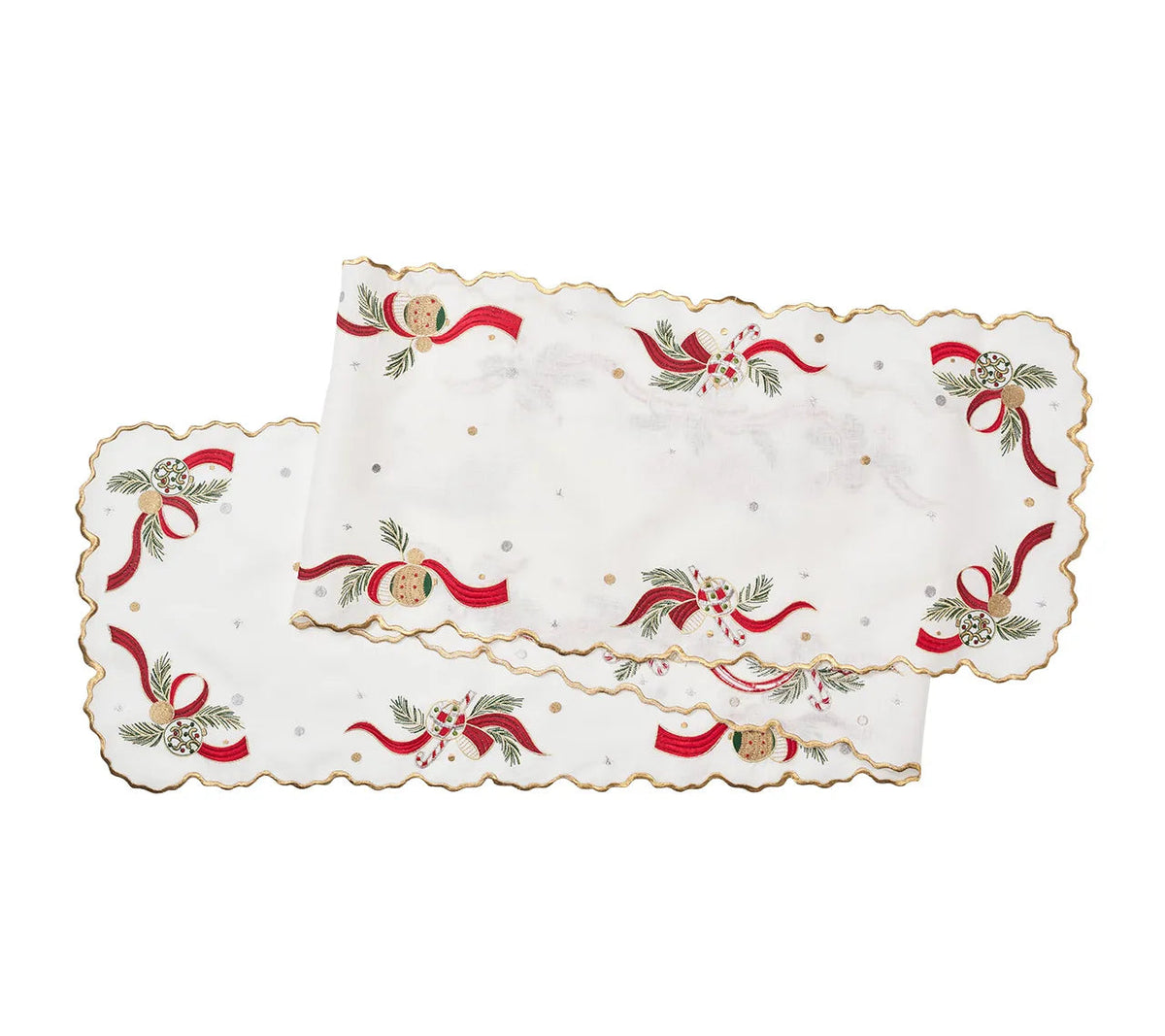 Kim Seybert Tinsel Bow table runner with white fabric, scalloped gold edges, and embroidery featuring red ribbons, pine sprigs, candy canes, and ornaments.