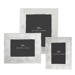 Three rectangular and square nickel Reflective Frame Collection picture frames by Michael Aram, each with different sizes and a black insert featuring the brand name and signature.