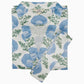 The Kaavia Robe by John Robshaw features a blue and green floral block print on crisp white fabric, complete with a matching belt and the signature “John Robshaw” label at the collar. Inspired by Jaipur’s traditional artistry, this piece blends timeless design with elegant comfort.