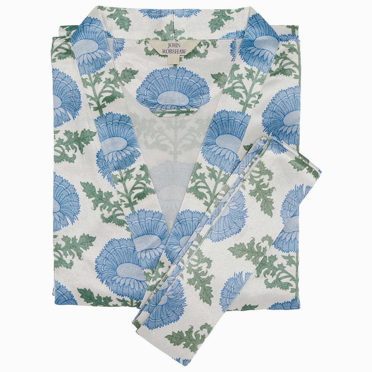 The Kaavia Robe by John Robshaw features a blue and green floral block print on crisp white fabric, complete with a matching belt and the signature “John Robshaw” label at the collar. Inspired by Jaipur’s traditional artistry, this piece blends timeless design with elegant comfort.