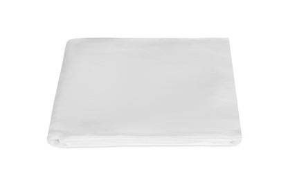 The Matouk White Roman Hemstitch Bedding Collection features a folded European linen bedsheet highlighted on a white background, showcasing its exquisite hemstitch detailing.