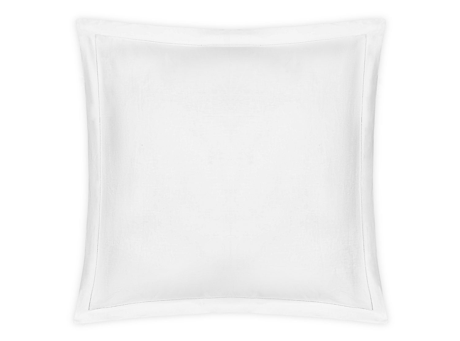 The Matouk White Roman Hemstitch pillow, featuring elegant hemstitch details and a subtle border design, rests gracefully on a neutral background, showcasing the refinement of our bedding collection.