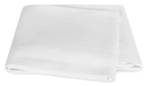 Two neatly folded sheets from the Matouk White Roman Hemstitch Bedding Collection are stacked, showcasing exquisite hemstitch detailing.