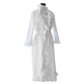 Experience plush comfort in the Haute Home Ruffle Robe, made from 100% white cotton sateen with ruffled trim and a tie belt, shown on a mannequin against a simple background.