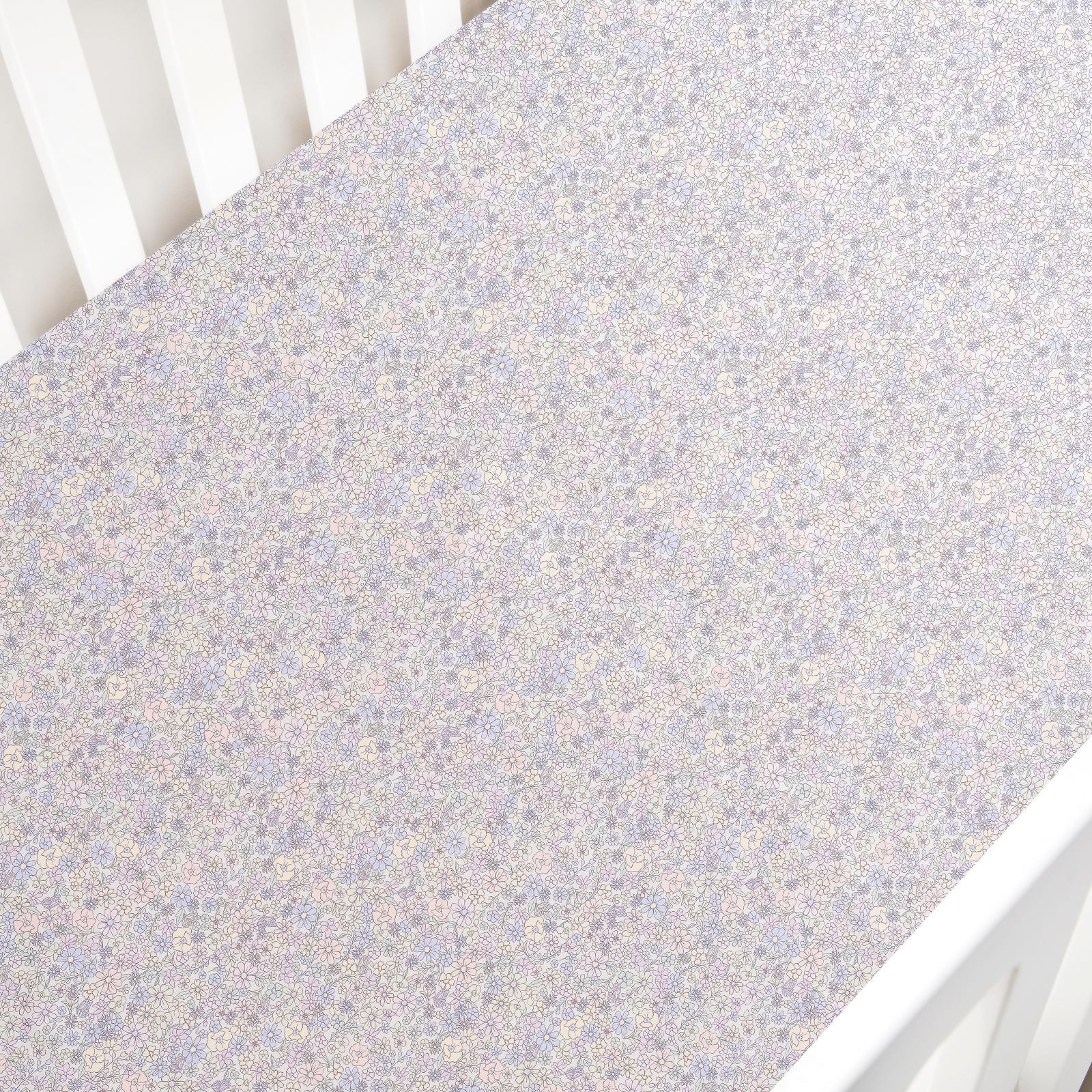 The Gooselings Enchanted Wildflowers Crib Sheet is a soft, OEKO-TEX certified cover with a delicate pastel floral pattern, perfect for your crib mattress.