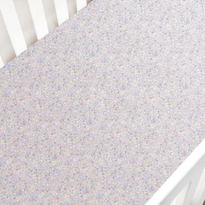 The Gooselings Enchanted Wildflowers Crib Sheet is a soft, OEKO-TEX certified cover with a delicate pastel floral pattern, perfect for your crib mattress.