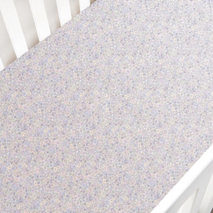 The Gooselings Enchanted Wildflowers Crib Sheet is a soft, OEKO-TEX certified cover with a delicate pastel floral pattern, perfect for your crib mattress.