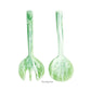 The Nashi Home Mint Resin Serveware Collection includes two green marbled serving utensils, a spoon and fork, displayed upright—stylish, shatter-resistant accents that make perfect home decor.