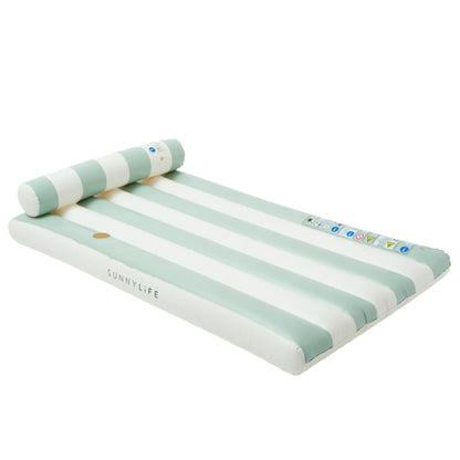The Luxe Lilo Green Stripe by Sunnylife is a striped inflatable pool lounger with a built-in pillow, featuring white and light green stripes and the "SUNNYLiFE" logo, inspired by Australian summer style for perfect lounging.