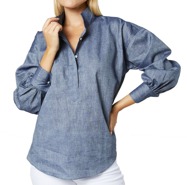 The model looks stunning in the Ann Mashburn Anaya Popover Shirt, a blue denim shirt that flatters her figure.
