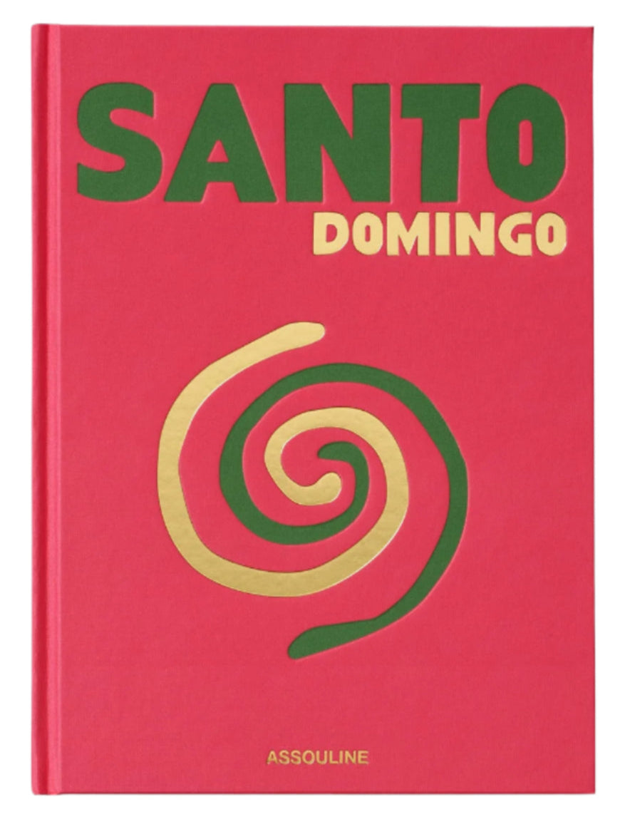 The red cover of "Santo Domingo," published by Assouline, features a gold and green spiral design reflecting the vibrant spirit of Zona Colonial.