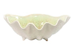 The Medium Clam Bowl Collection by AE Ceramics features a white ceramic bowl with a glossy, light yellowish-green interior and a wavy scalloped rim—an elegant piece of coastal dinnerware.
