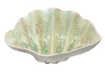 The Large Clam Bowl Collection by AE Ceramics features glossy, pale green and cream ceramic bowls shaped like scallop shells—ideal for coastal dinnerware enthusiasts and handmade ceramics fans.