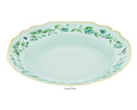 Light blue porcelain soup plate with scalloped edges, gold detailing and rim, green floral motifs, and a butterfly from the Aquazzura Casa Secret Garden Dinnerware and Serveware Collection.