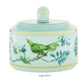 Porcelain sugar bowl with lid, adorned with a green bird and floral design on a light blue background, from the captivating Aquazzura Secret Garden Collection by Aquazzura Casa.