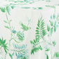 The Aquazzura Casa Secret Garden Table Linen Collection features a white tablecloth with green botanical and bird prints, ideal for a coordinated dining look when paired with matching placemats or napkins.